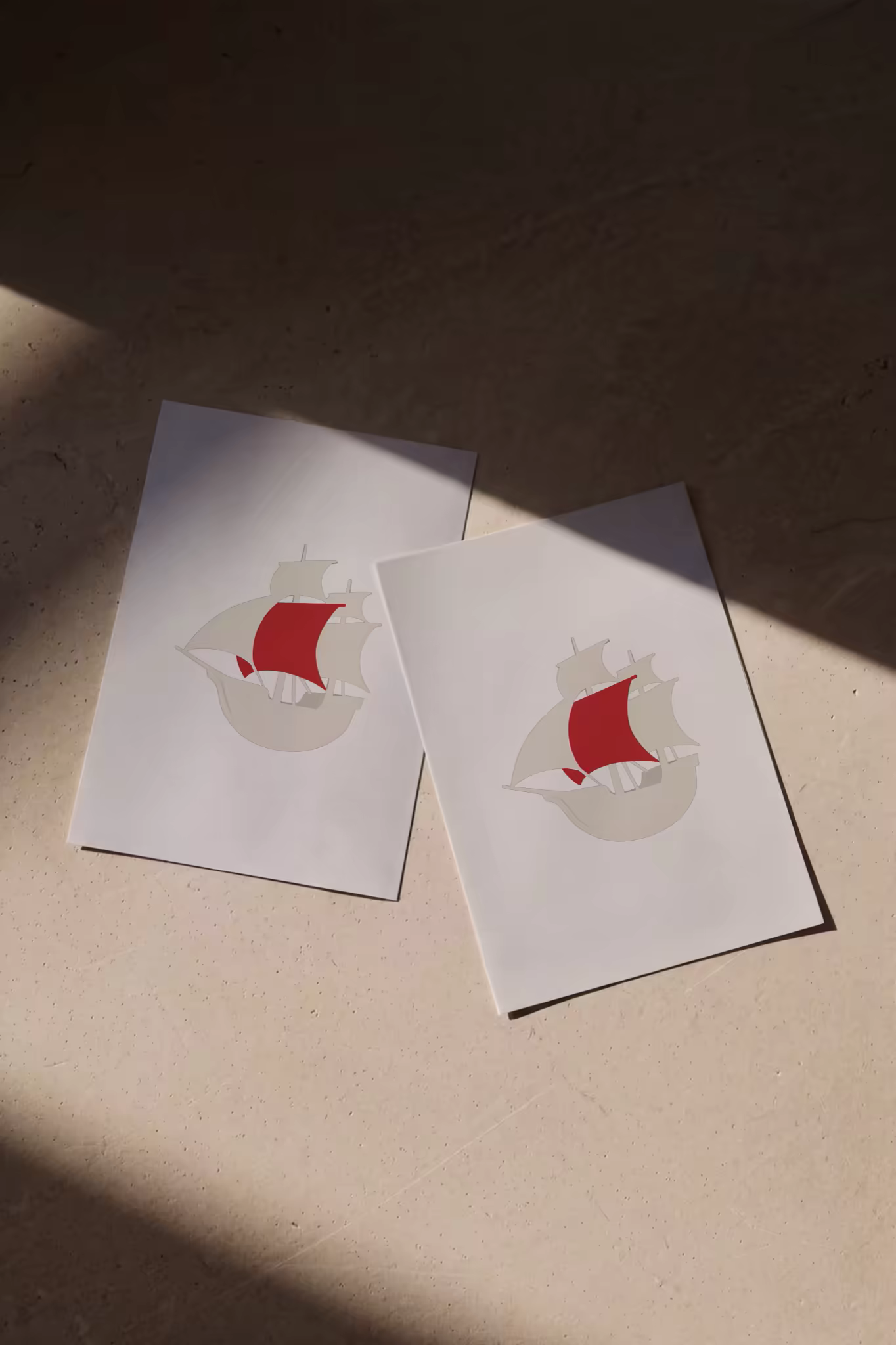 Booklet Mockup Pair on a Sunlit Plaster Surface