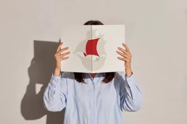 Open Book Mockup Held Up Before the Face