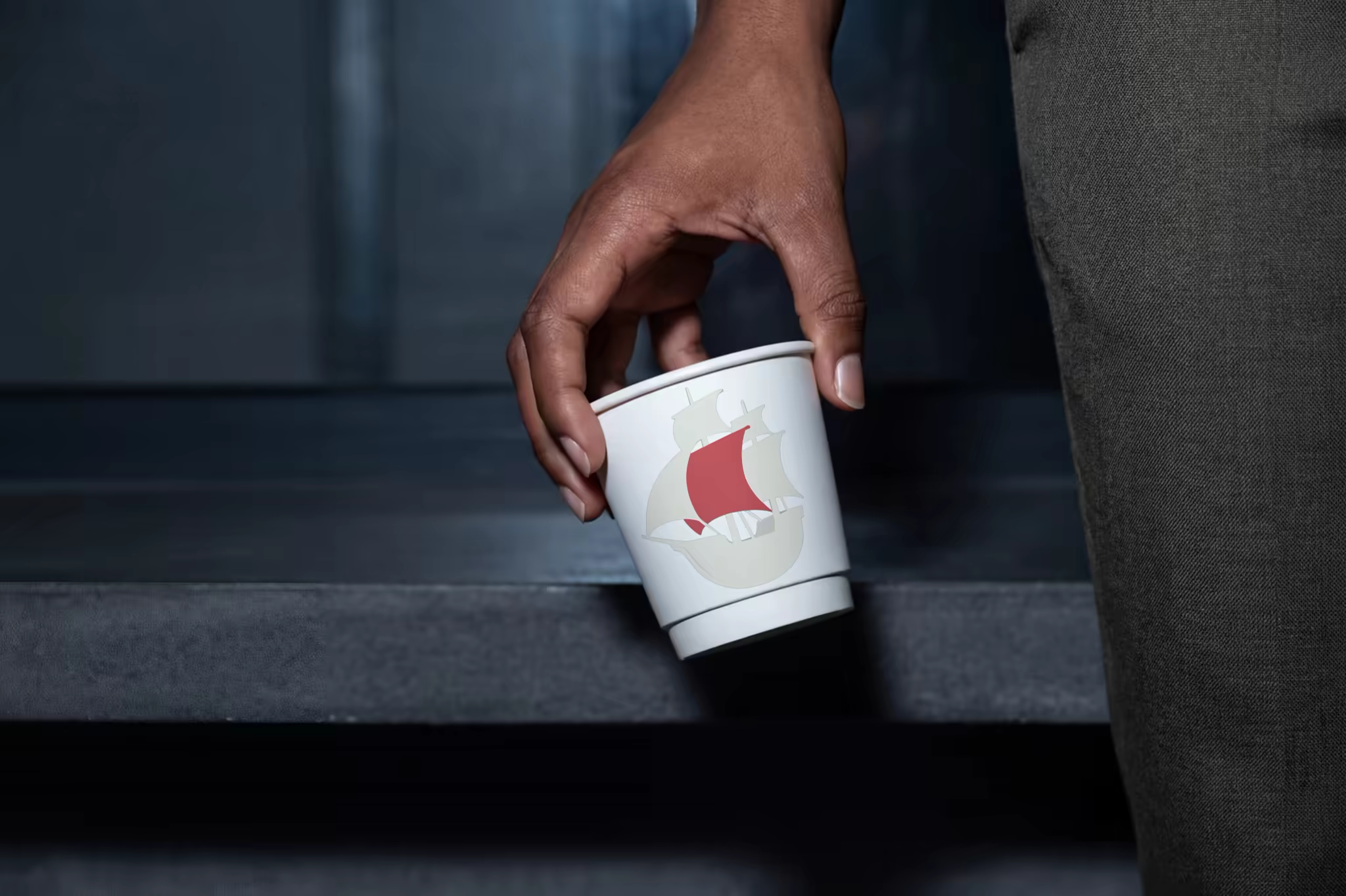 Paper Cup Mockup Lifted From a Stone Bench