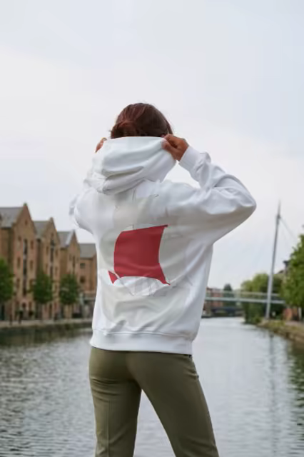 White Hoodie Mockup Back View by a City Canal