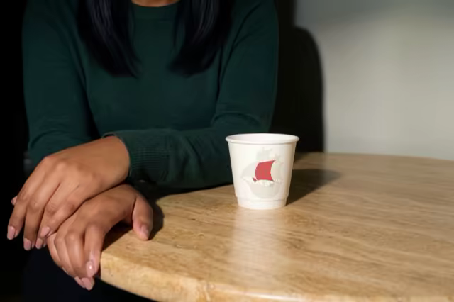 Coffee Cup Mockup on a Round Cafe Table