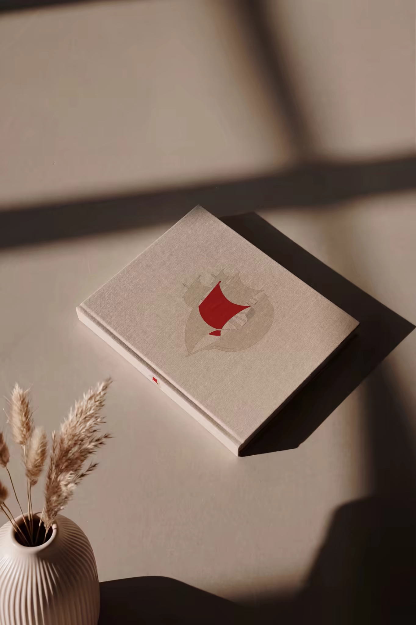 Hardcover Book Mockup Beside Dried Pampas Grass