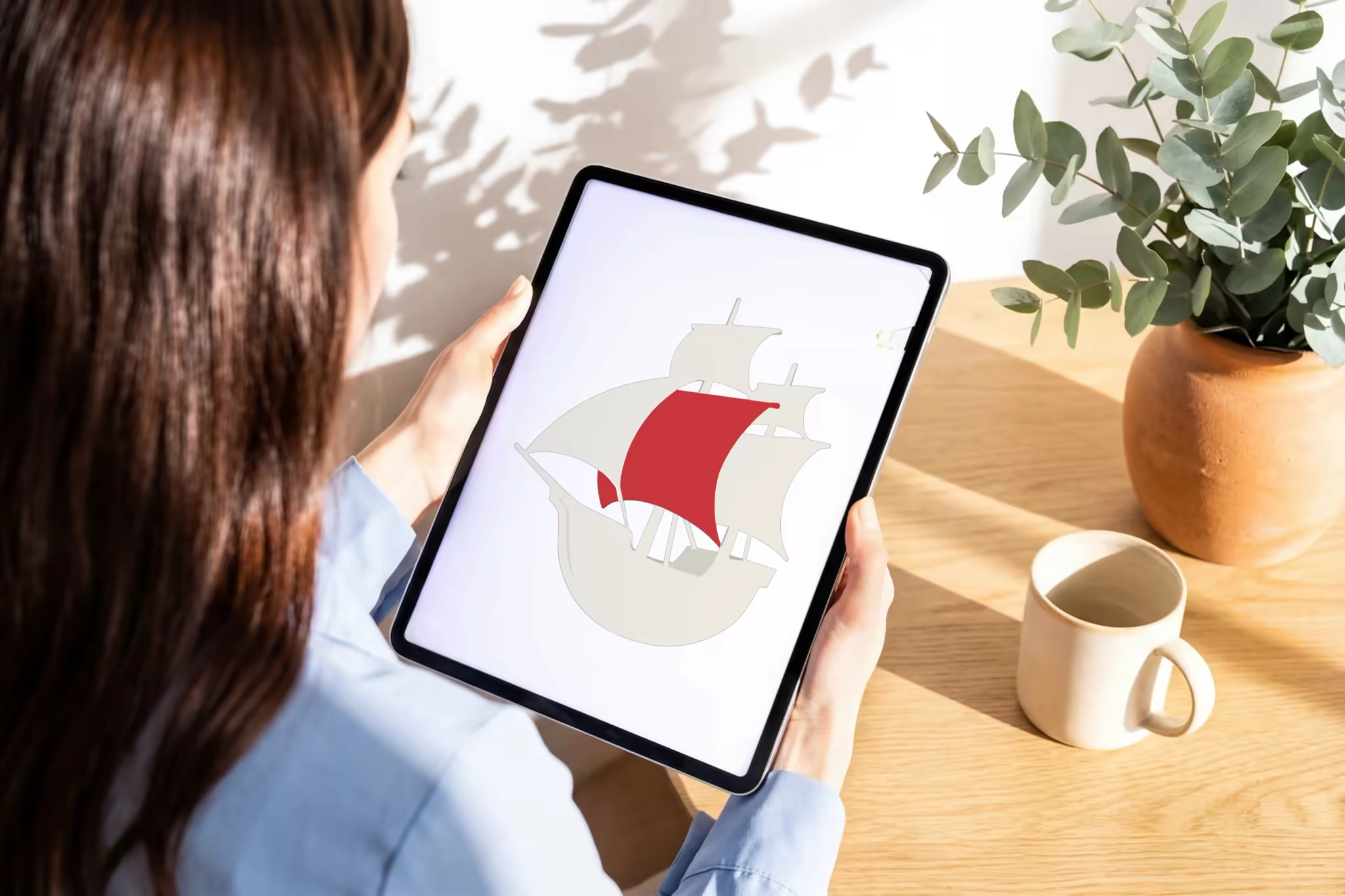 Handheld Tablet Mockup at a Bright Home Desk