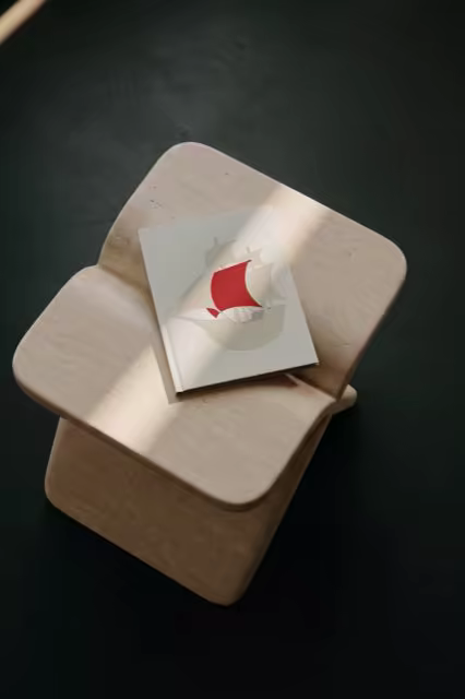 Softcover Book Mockup on a Pale Wooden Stool