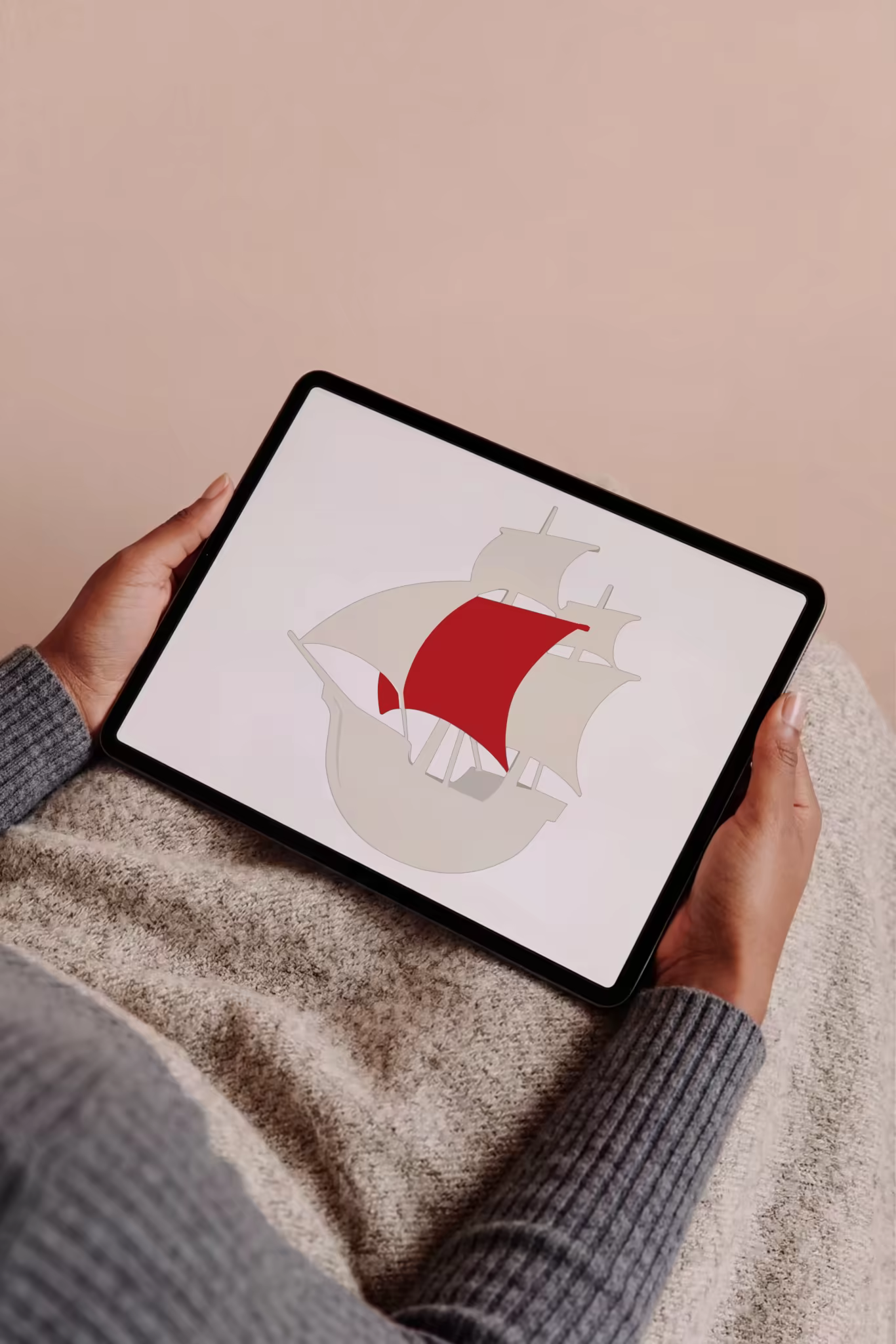 Tablet Mockup Held Over a Gray Knit Sweater