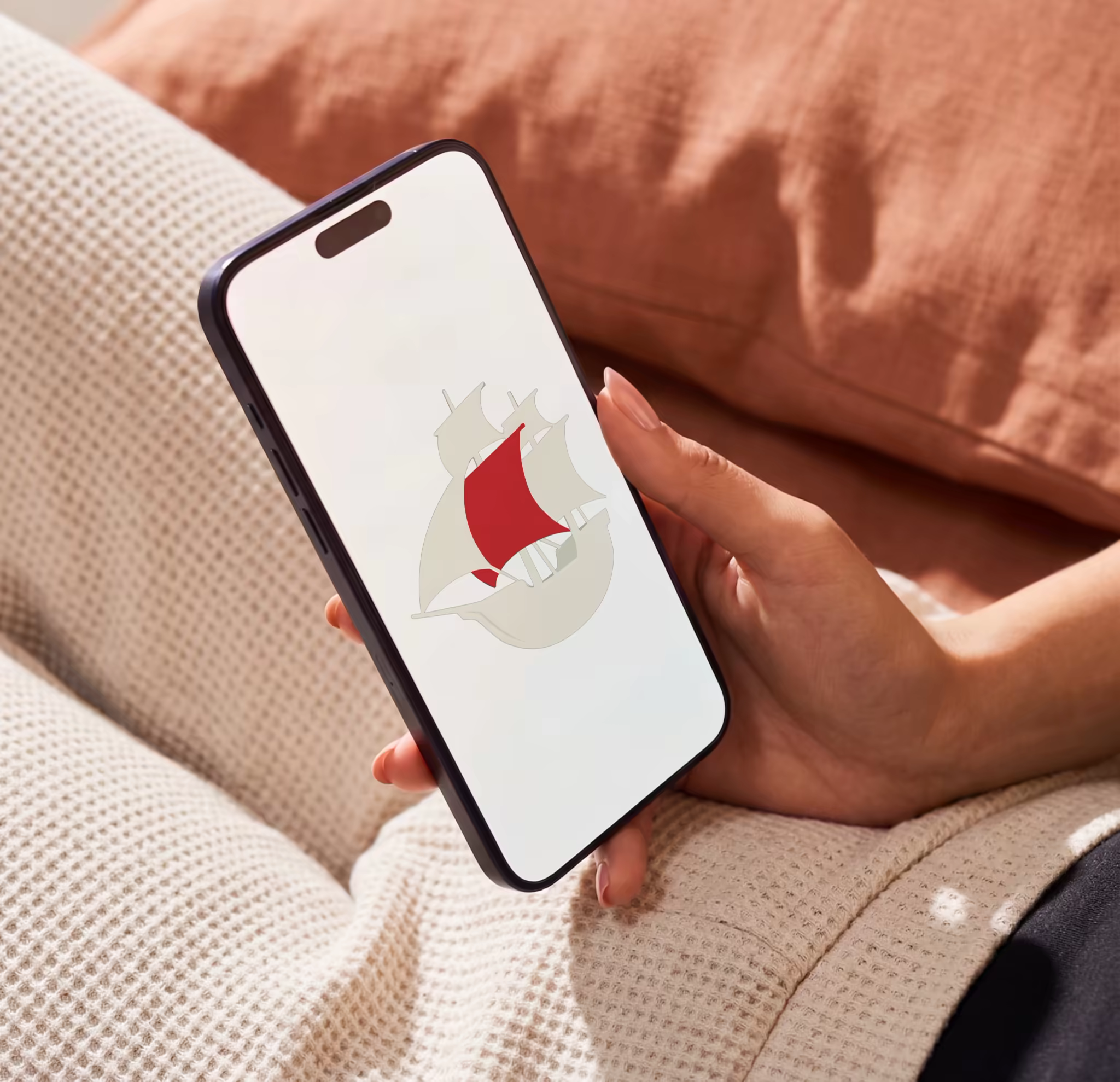 Smartphone Mockup in Hand Over Terracotta Bedding