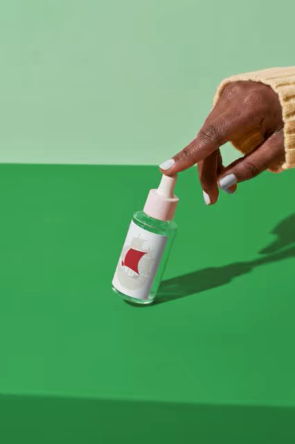 Dropper Bottle Mockup on a Bold Green Tabletop