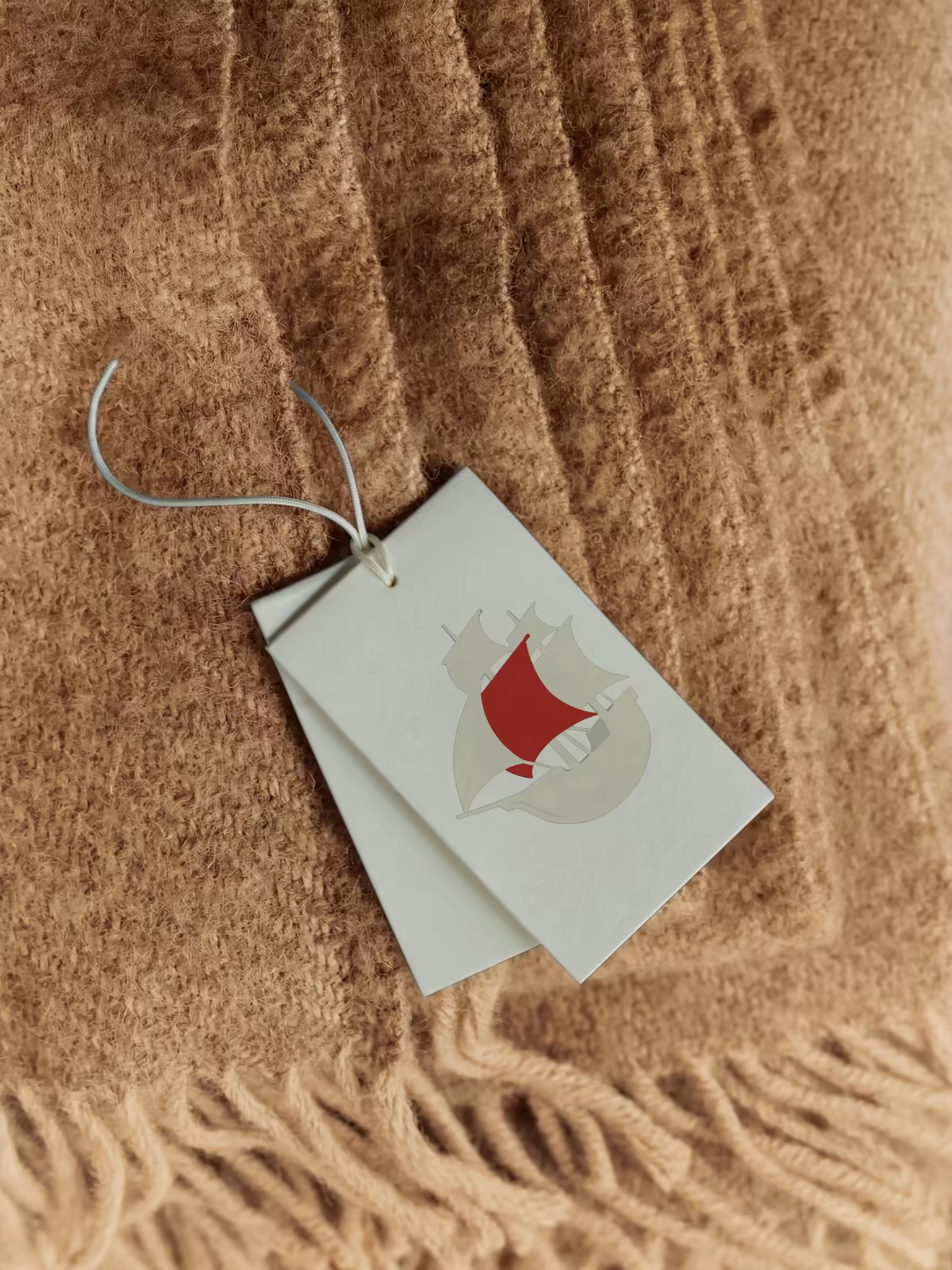 Swing Tag Mockup on a Camel Wool Blanket