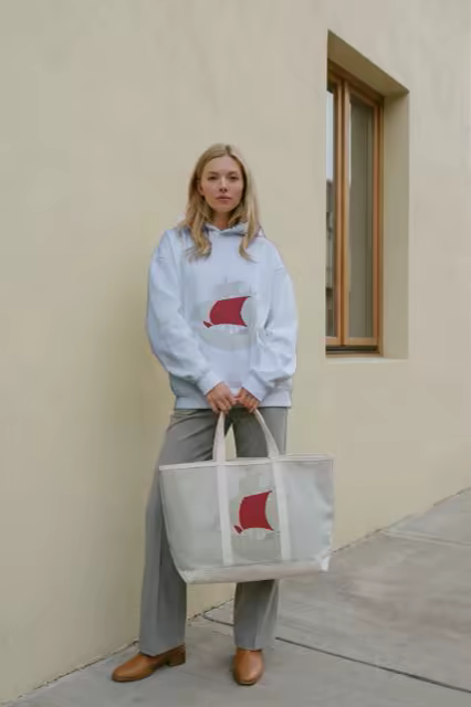 Canvas Tote Bag Mockup Held by a Stucco Wall