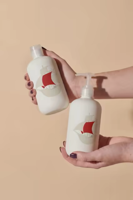Lotion Bottle Mockup Pair on a Peach Backdrop