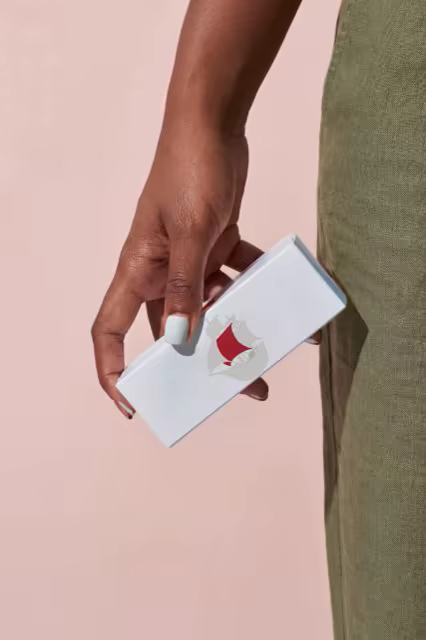 Cosmetic Box Mockup in Hand on a Blush Backdrop