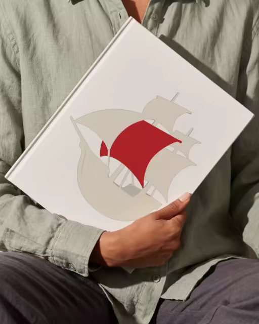 Hardcover Book Mockup Held in a Sage Linen Shirt