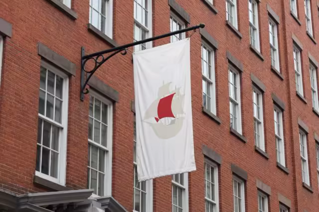 Hanging Flag Banner Mockup on a Red Brick Facade