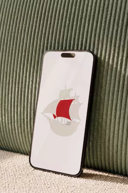 Phone Mockup Leaning on a Green Corduroy Sofa