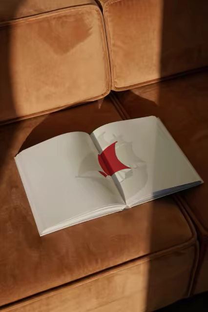 Open Hardcover Book Mockup on a Velvet Sofa