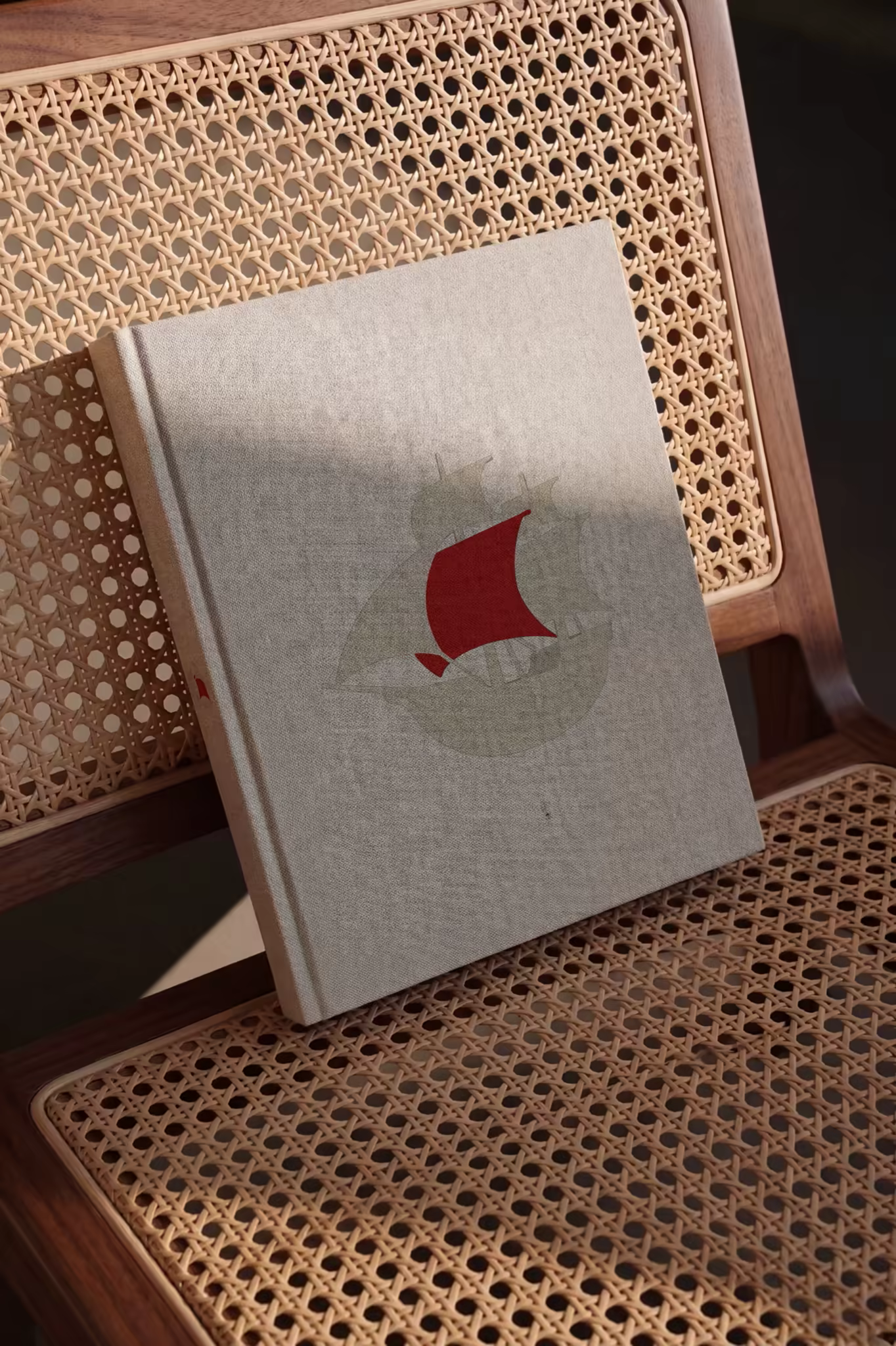 Linen Hardcover Book Mockup on a Cane Chair