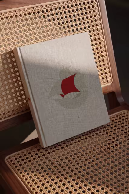 Linen Hardcover Book Mockup on a Cane Chair