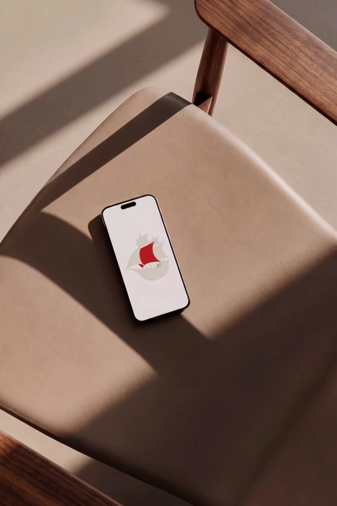 Phone Mockup on a Tan Leather Armchair
