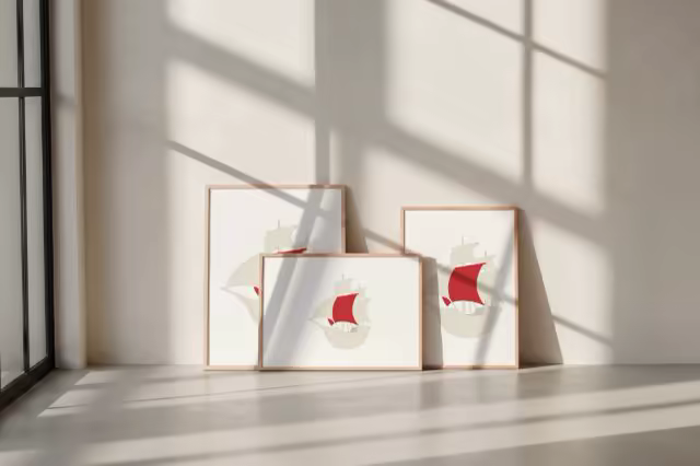 Framed Poster Mockup Trio Against a Cream Wall
