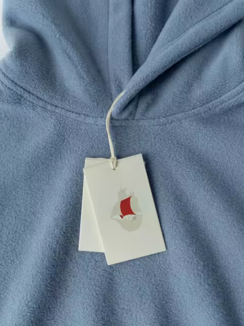 Hang Tag Mockup on a Light Blue Fleece Hoodie