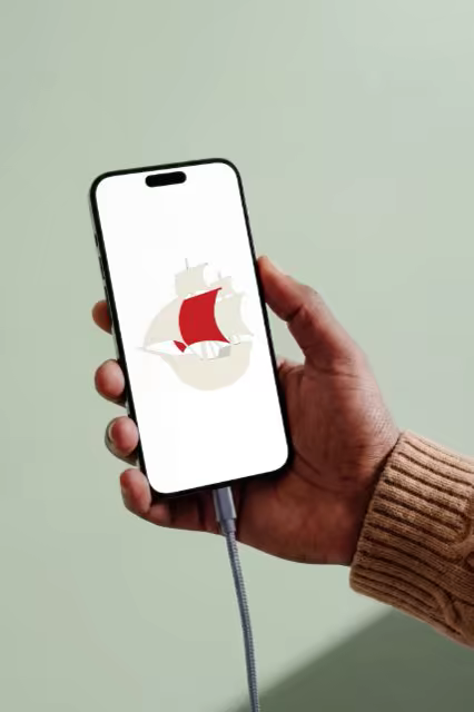 Phone Screen Mockup Held Against a Sage Wall