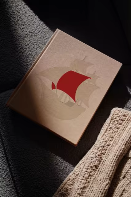 Hardcover Book Mockup on a Charcoal Boucle Sofa
