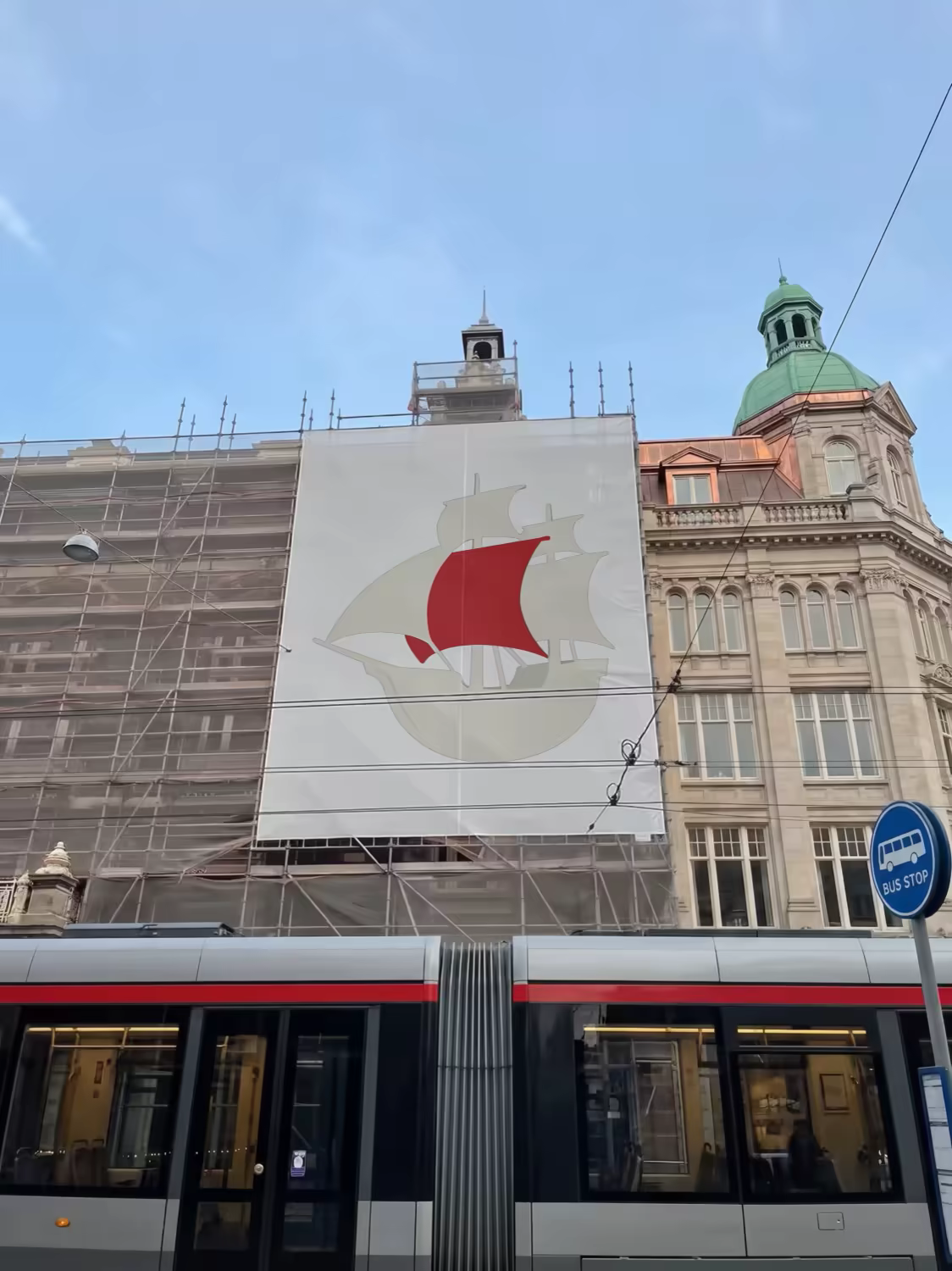 Building Banner Mockup Over a Passing Tram
