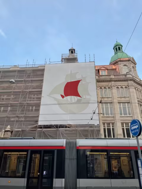 Building Banner Mockup Over a Passing Tram