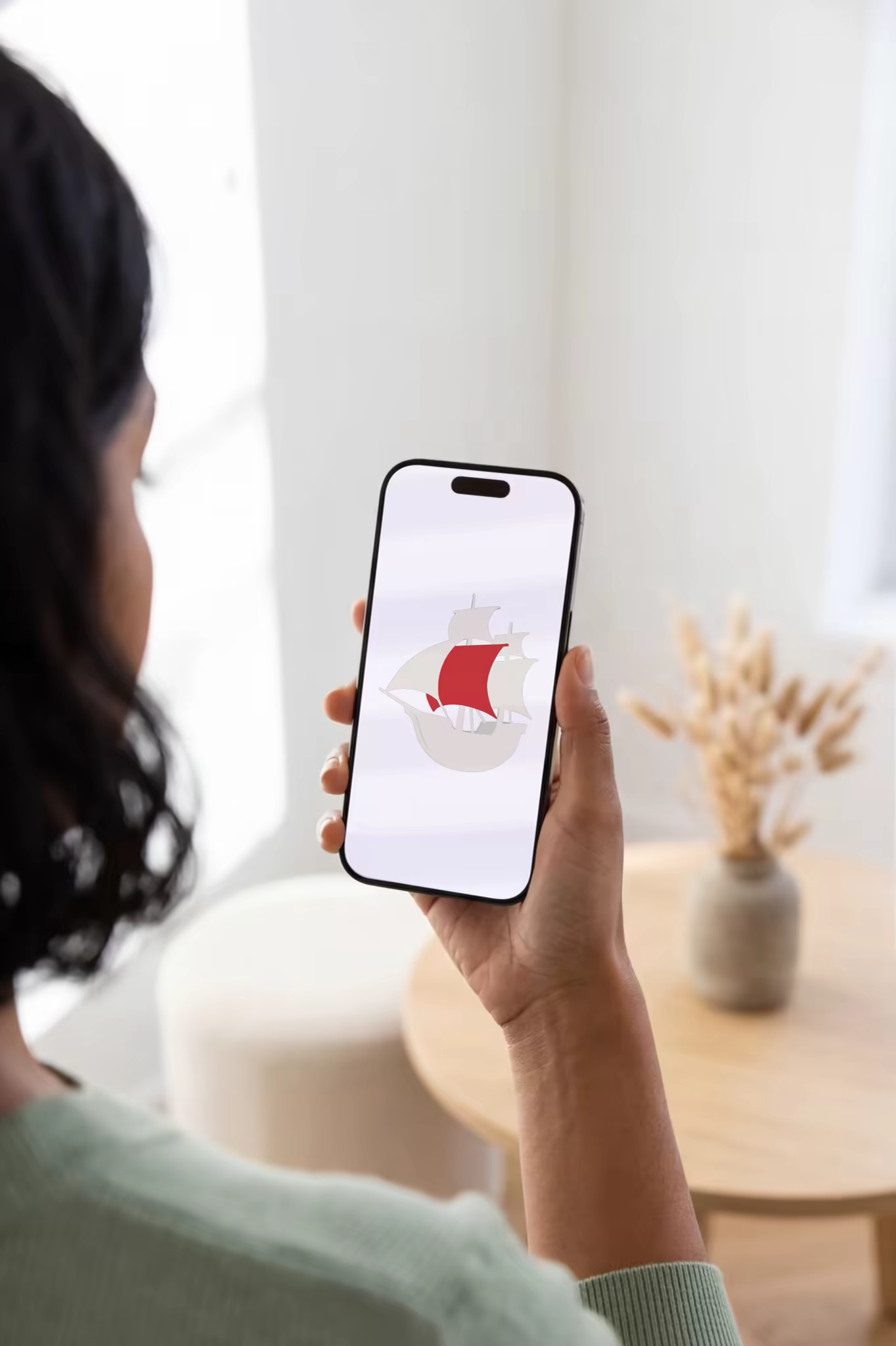 Handheld Phone Mockup in a Bright Living Room