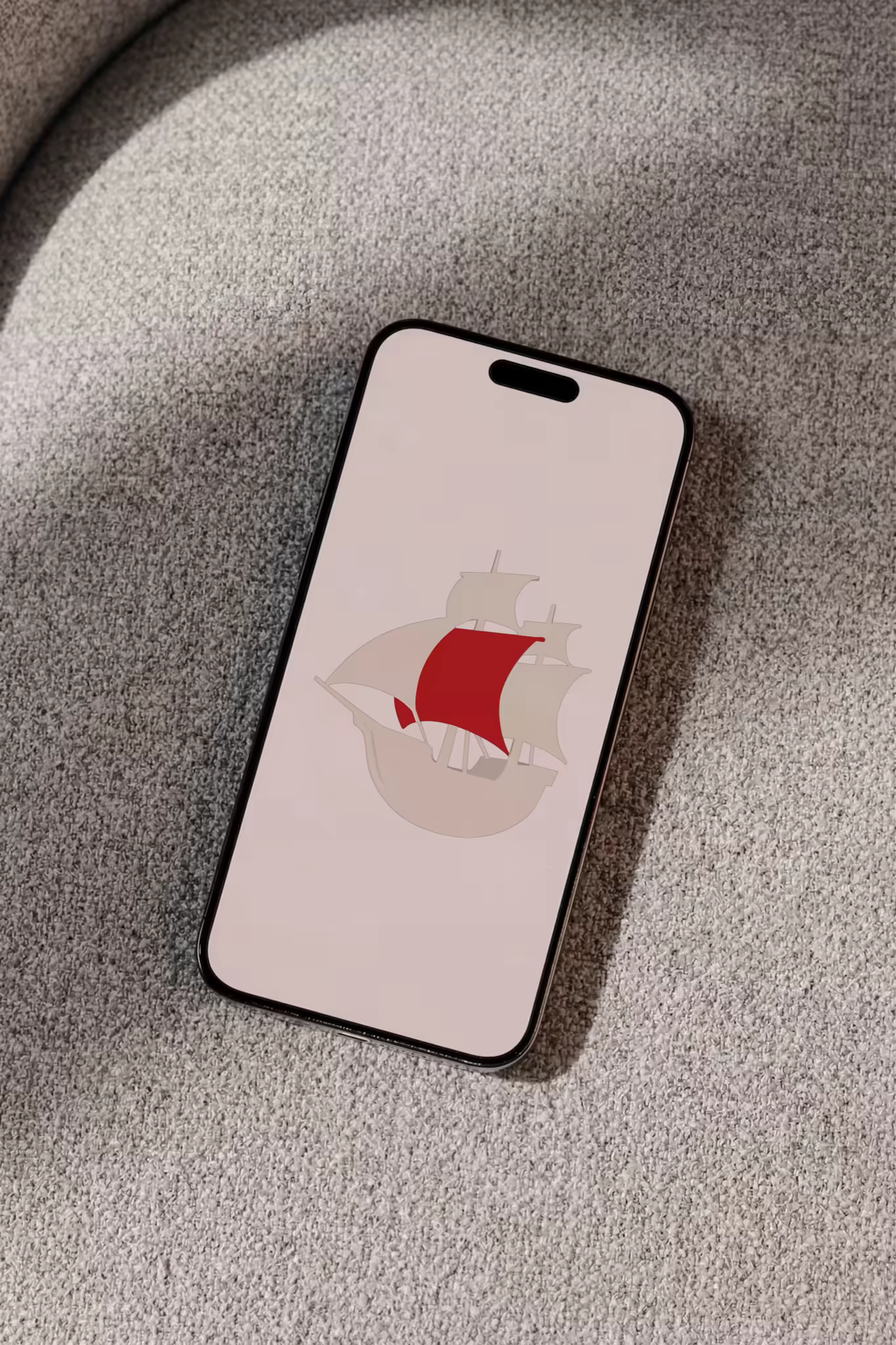 Smartphone Mockup on a Gray Boucle Sofa