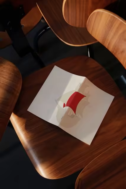 Open Booklet Mockup on a Molded Plywood Chair