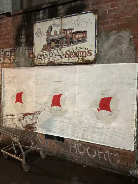 Wheatpaste Poster Mockup on a Brick Wall at Night