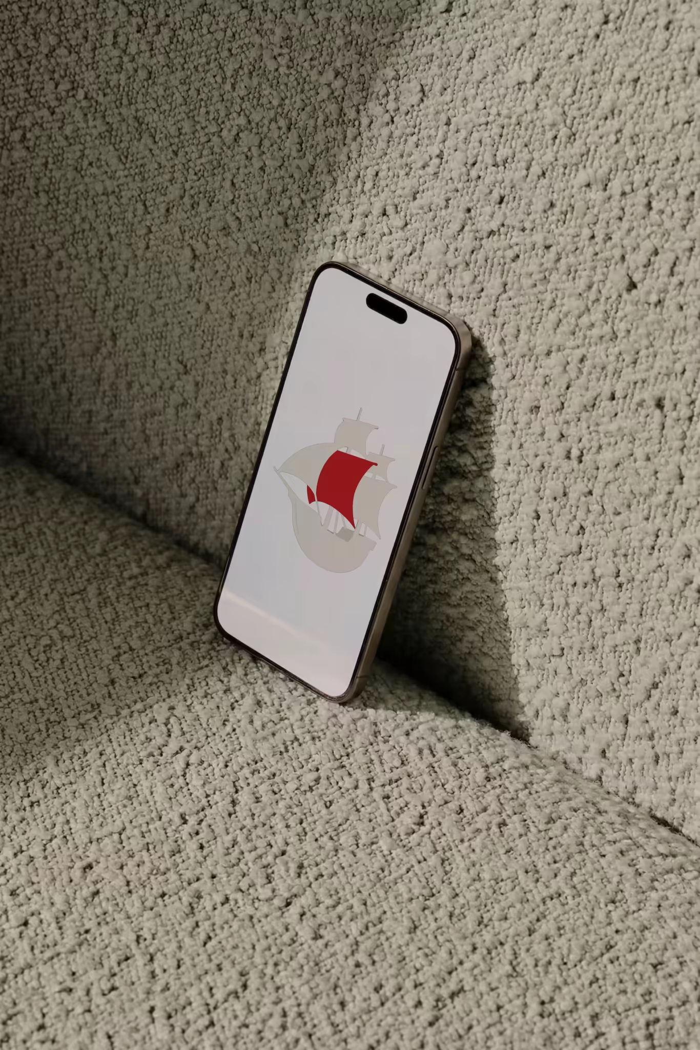 Phone Mockup Leaning on a Pale Boucle Cushion