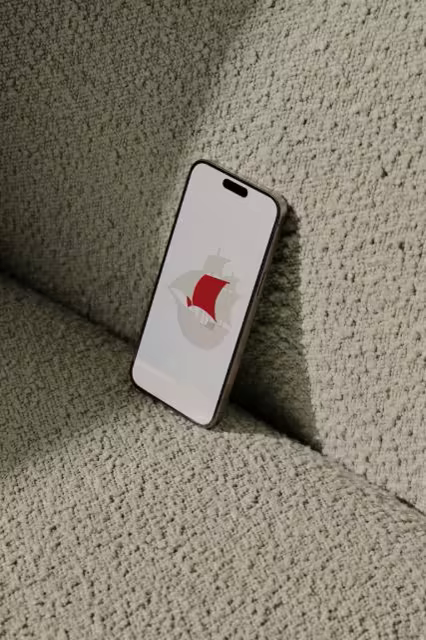 Phone Mockup Leaning on a Pale Boucle Cushion