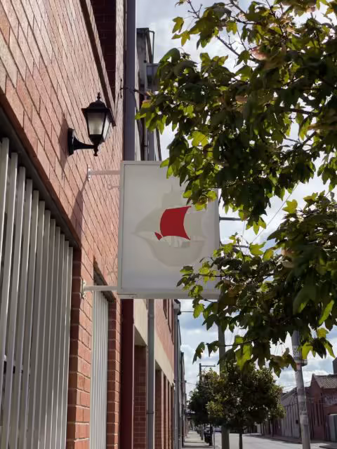 Projecting Shop Sign Mockup on a Red Brick Facade