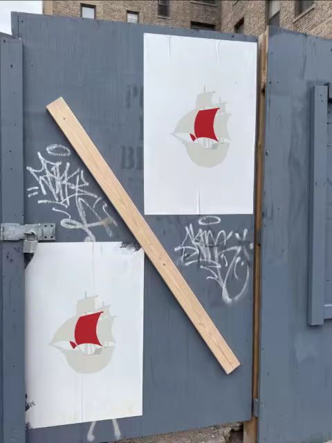 Wheatpaste Poster Mockup on a Gray Site Hoarding