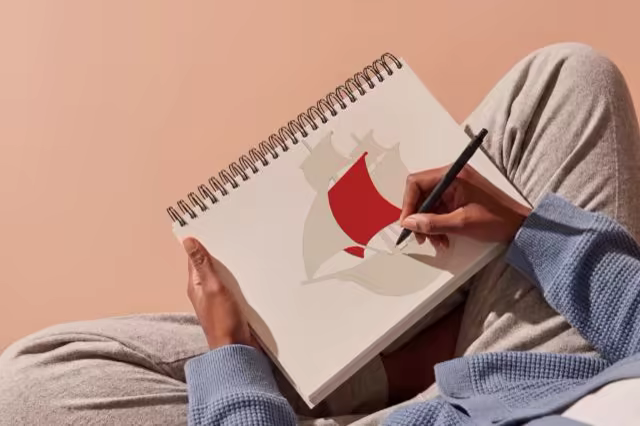 Spiral Sketchbook Mockup Held in a Cozy Lap