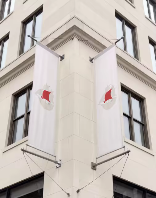 Vertical Flag Banner Mockup on a Stone Corner