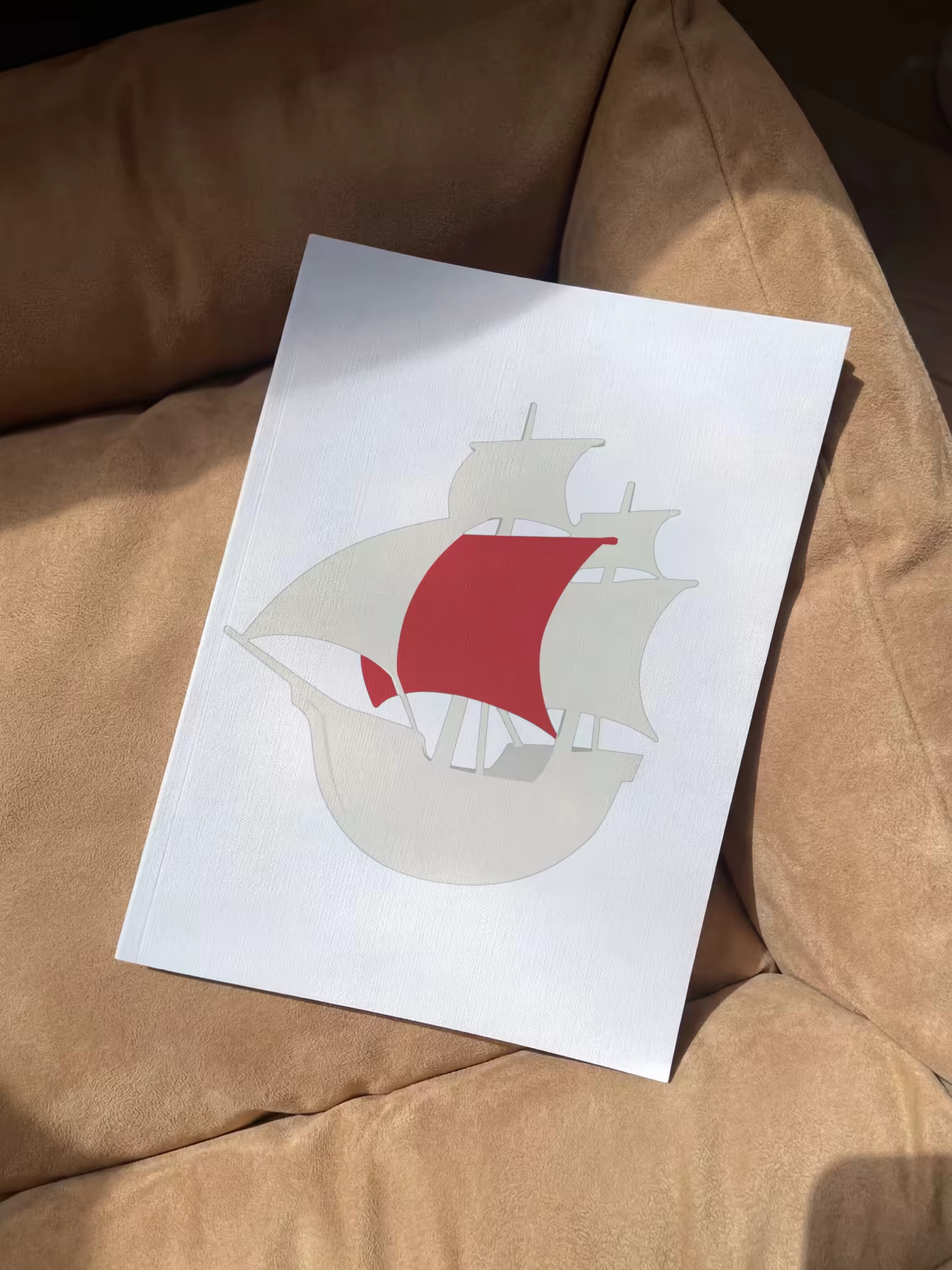 Softcover Book Mockup on a Tan Suede Sofa