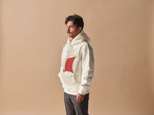 Cream Hoodie Mockup Worn in a Warm Studio