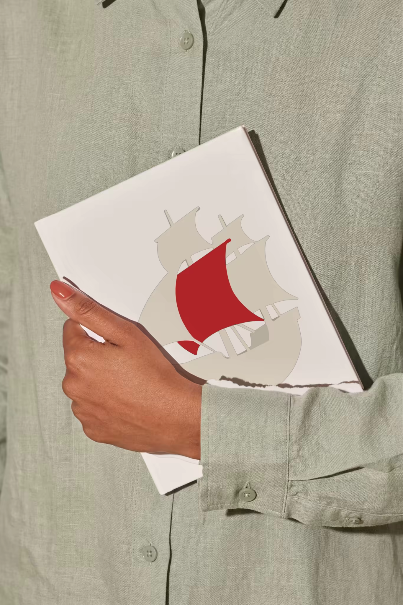Book Mockup Carried Against a Sage Linen Shirt