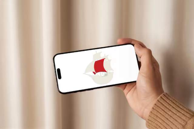 Phone Mockup Held Sideways by a Beige Curtain