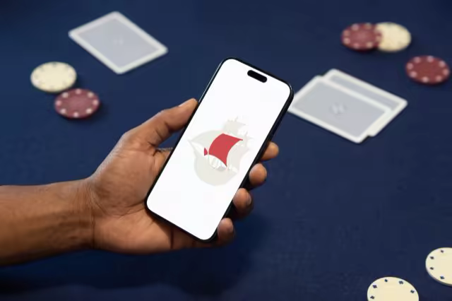 Phone Mockup Held Over a Navy Card Table