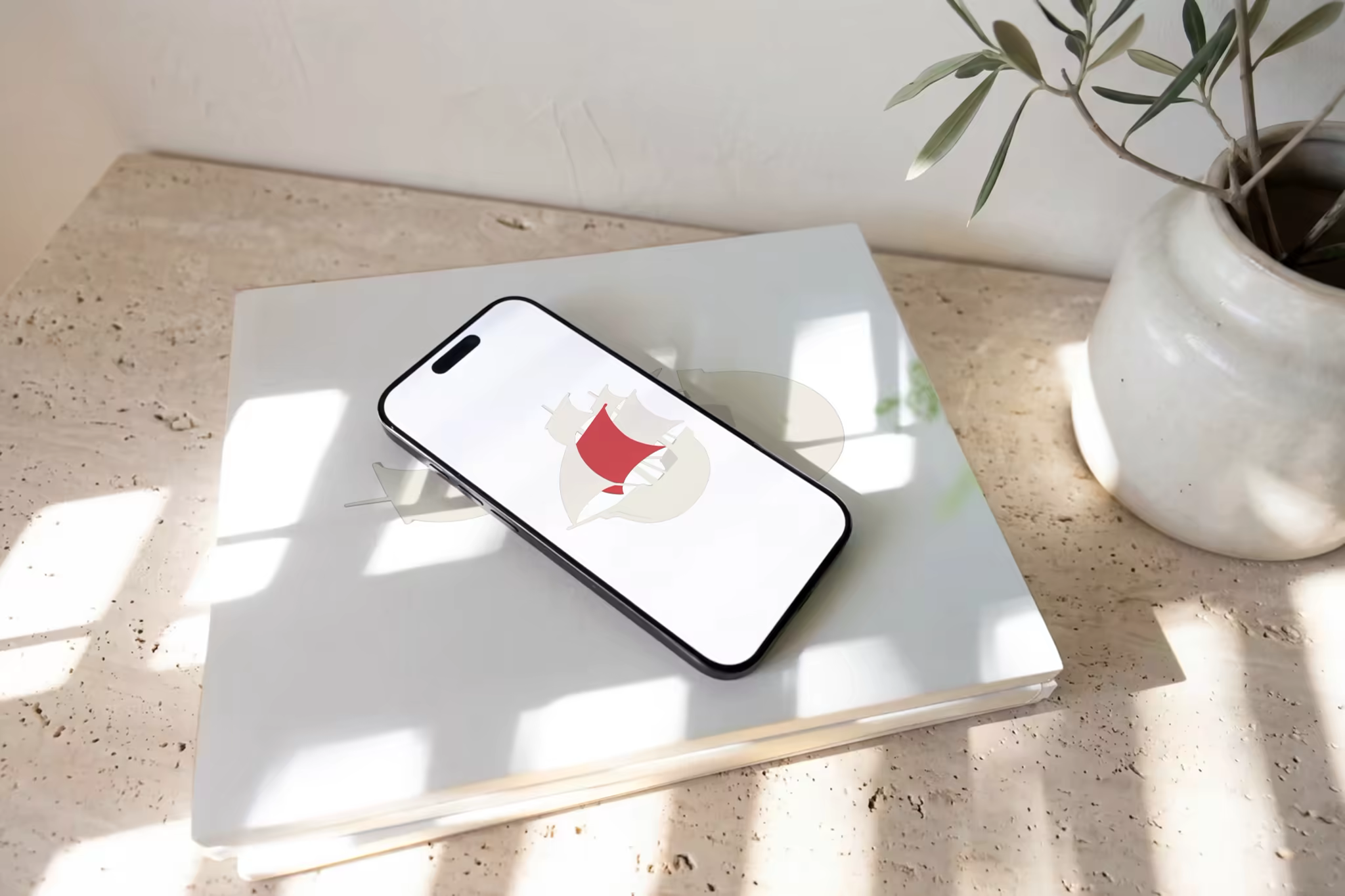 Phone Mockup on Stacked Books in Dappled Sun