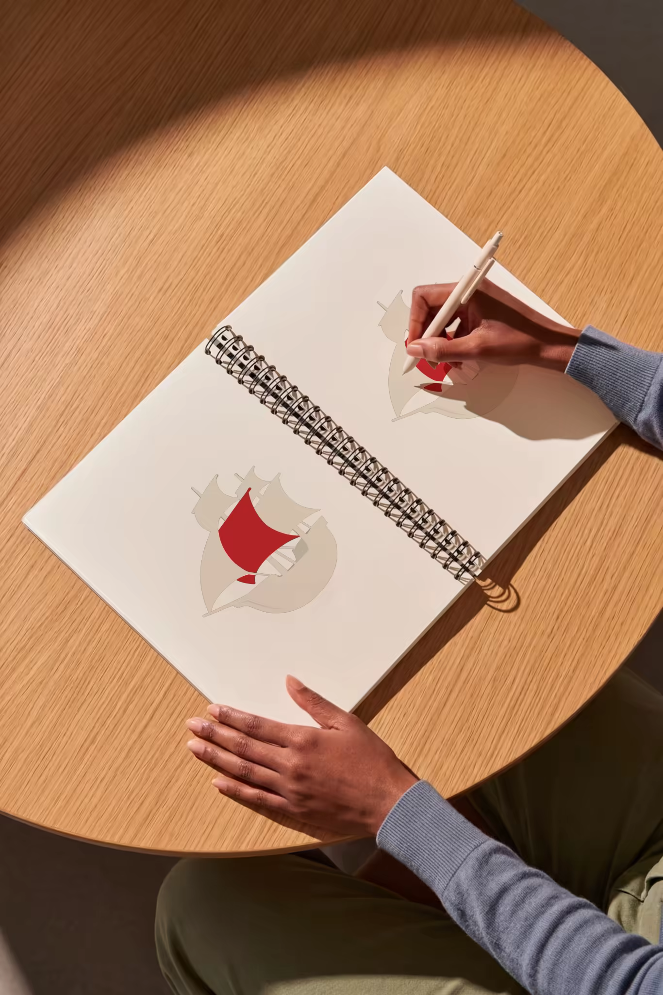 Spiral Sketchbook Mockup on a Round Oak Table