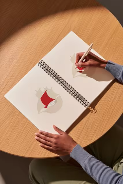 Spiral Sketchbook Mockup on a Round Oak Table