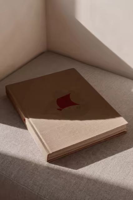 Linen Hardcover Book Mockup on a Gray Cushion