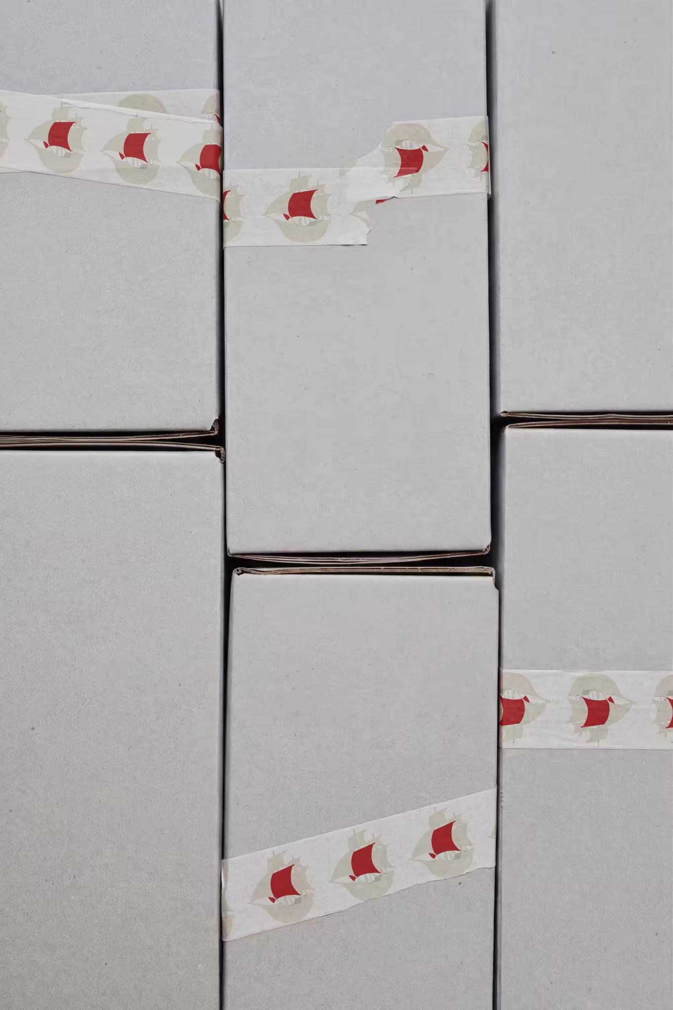 Printed Tape Mockup Across Stacked Gray Parcels