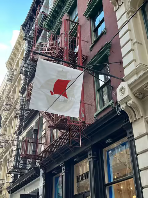Storefront Flag Banner Mockup on a Brick Facade