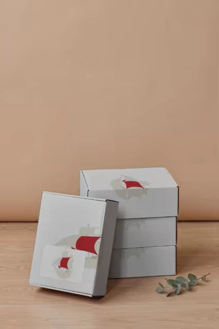 Mailer Box Mockup Stack Against a Peach Wall